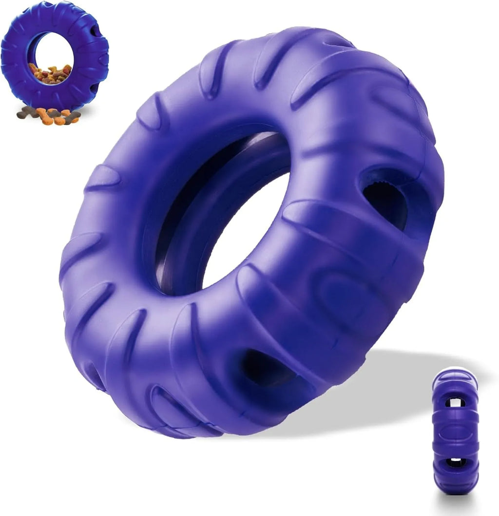 Blue tyre-shaped dog chew toy with oval openings for treat dispensing on a wooden floor.