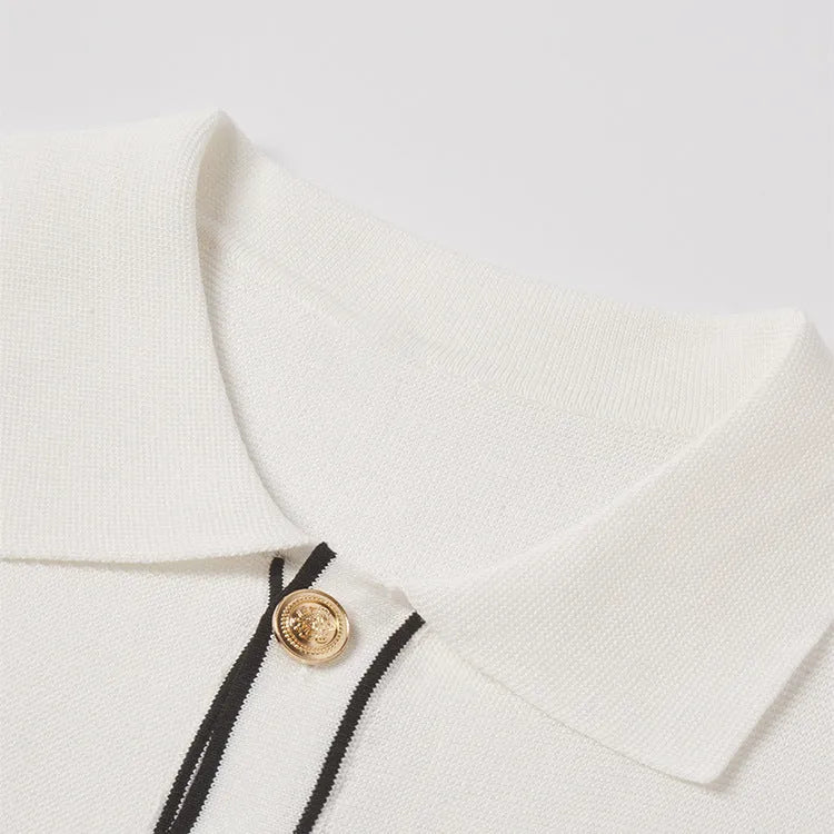 White short sleeve cardigan with dark contrast colour lapels laid flat.