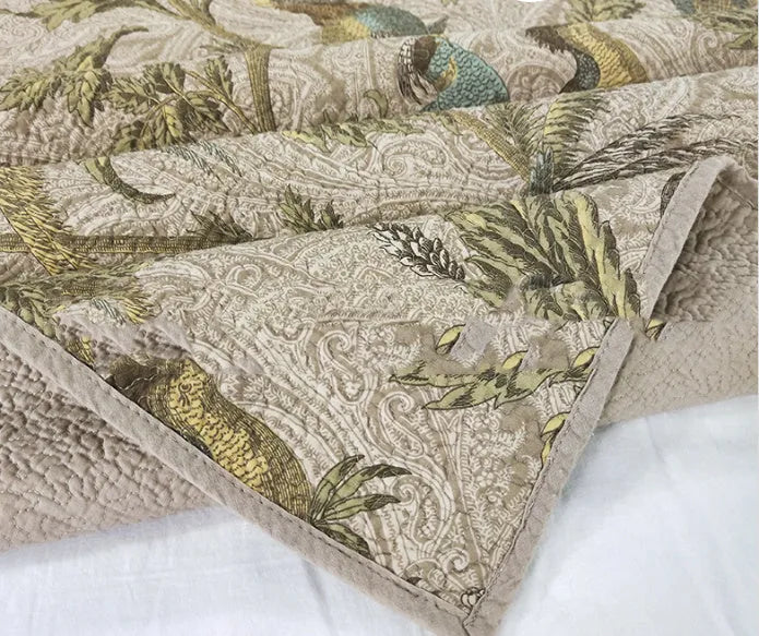 Blue American floral pattern cotton quilted bedspread set with three pieces on a bed