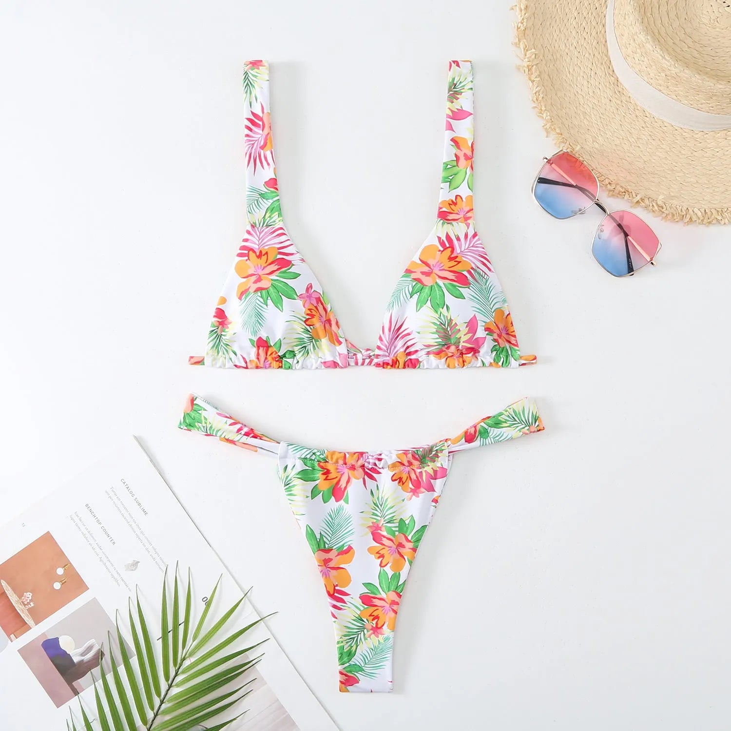 Women's blue floral print bikini top and briefs set on a white background