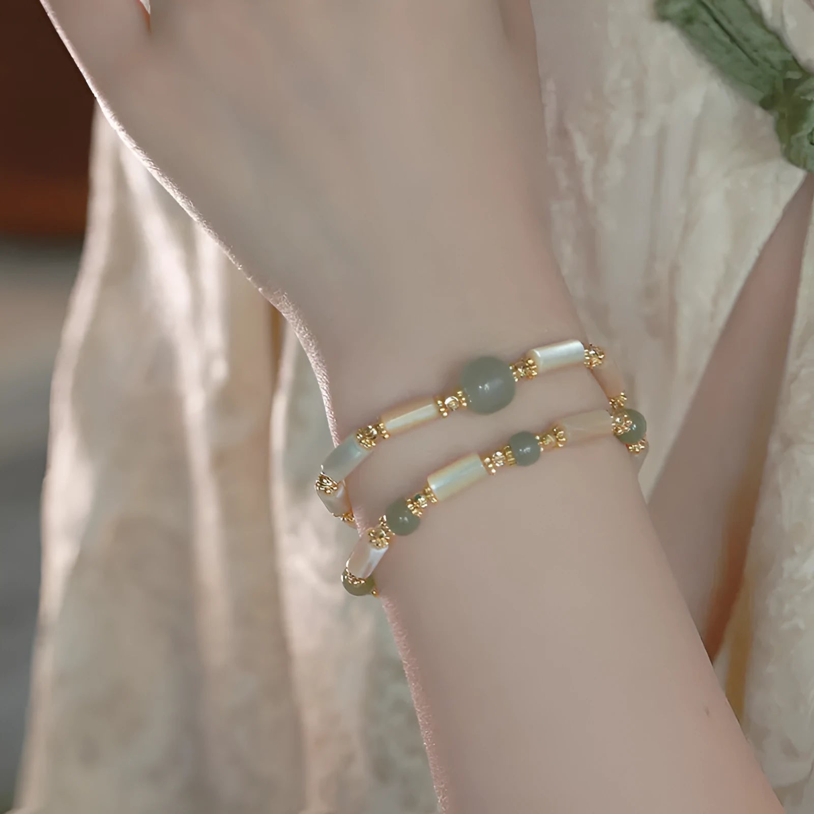 Handmade women's Hetian jade bracelet with round beads in geometric design on wrist
