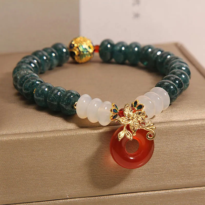 Blue water jade abacus bead crystal bracelet with red agate peace buckle and rhinestone details