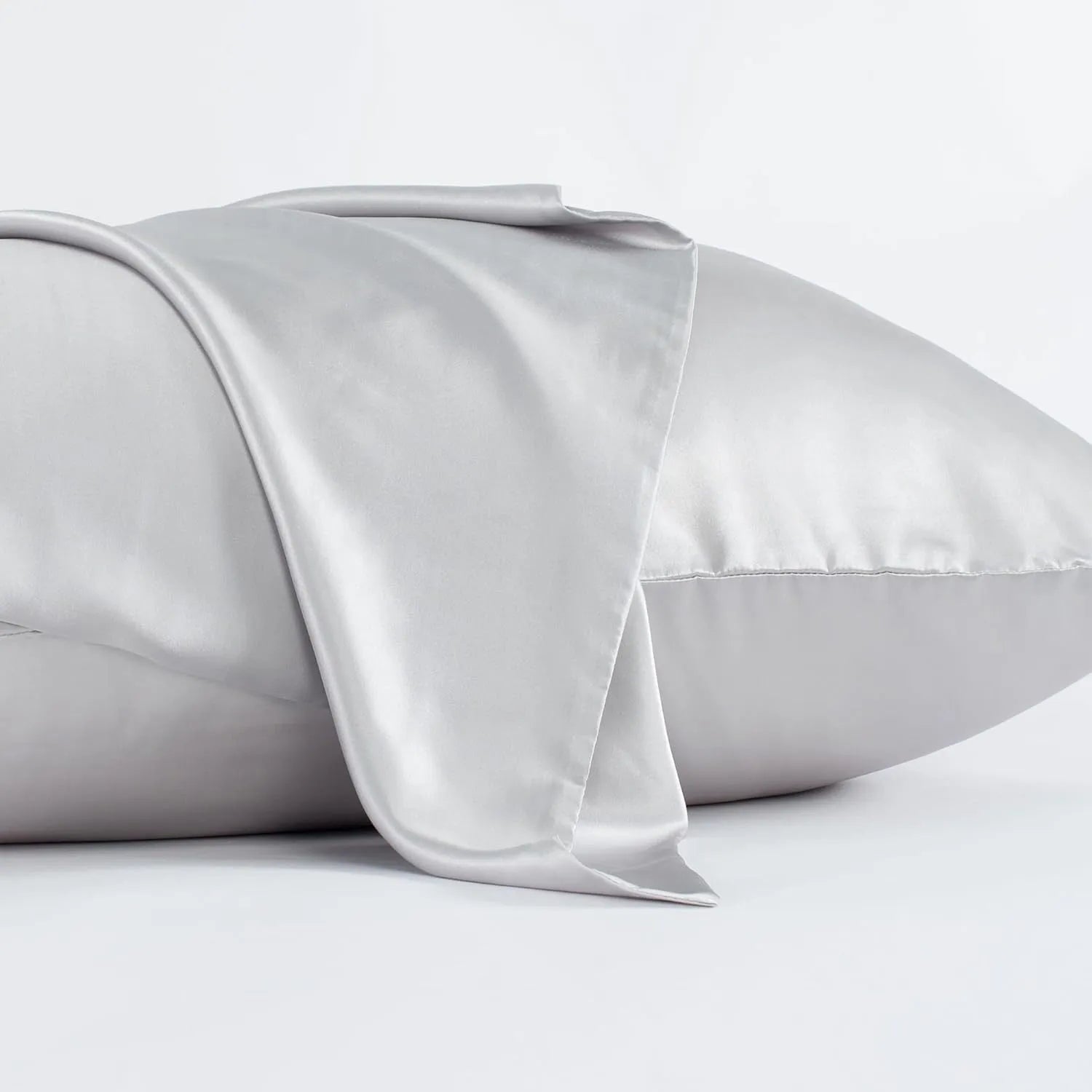Solid colour mulberry silk envelope pillowcase in dark grey on a bed.