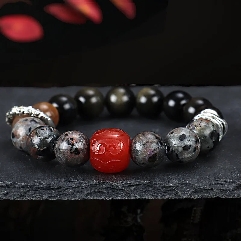 Gold obsidian flame stone red agate Wukong unisex bracelet on display showing natural stone beads