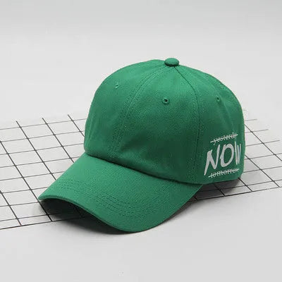 Cotton baseball cap with letter embroidery, curved brim, dome top, adjustable size, in green colour.