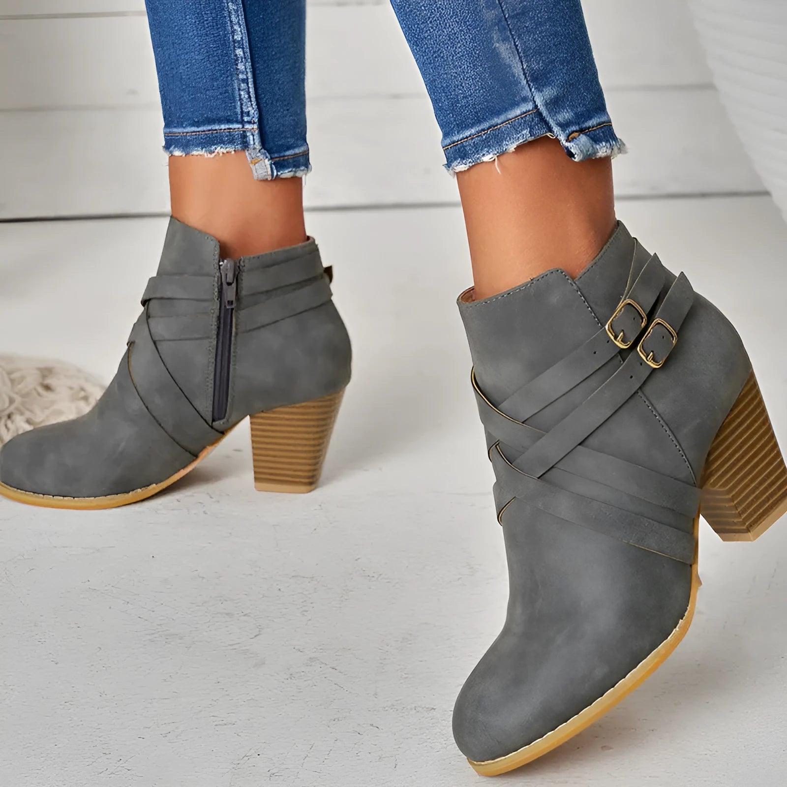 Men's black short ankle boots with side zip, belt buckle, and a 7cm heel.