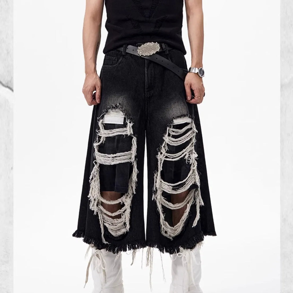 Black women's cropped wide leg jeans with distressed patches and a mid-high waist.