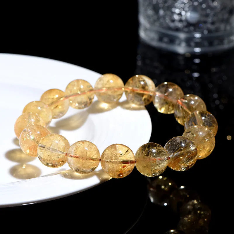 Natural yellow Asestelle citrine bracelet with hand-ground geometry beads on a wrist.