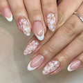 Short almond shaped artificial nails with French style and glittering powder flower design in C625 colour