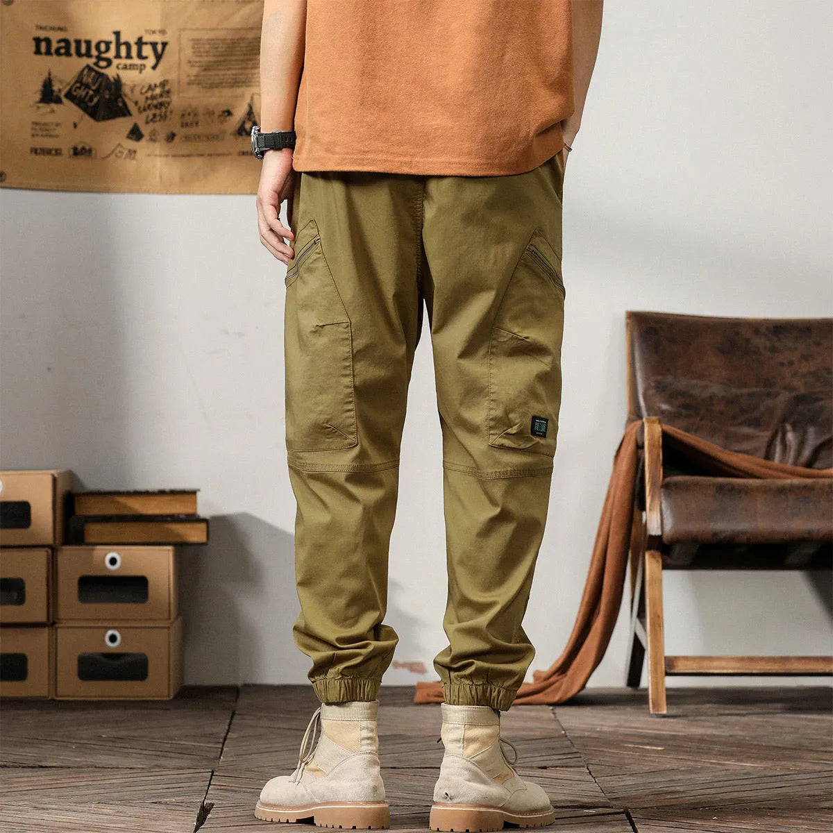 Men's loose fit cotton trousers with tapered ankle banded legs in khaki colour.
