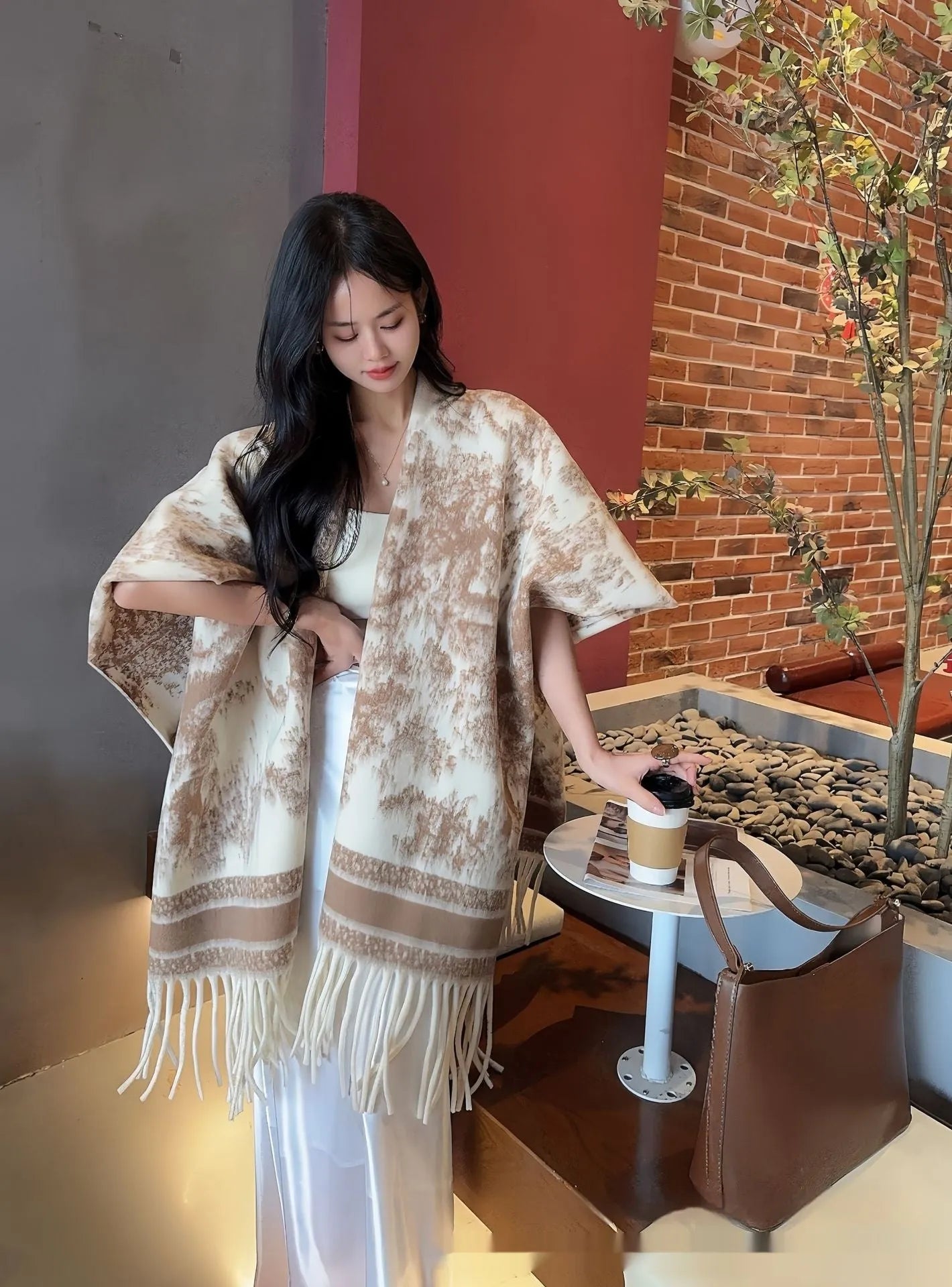 Women's casual polyester scarf cape with tassels worn as a shawl.