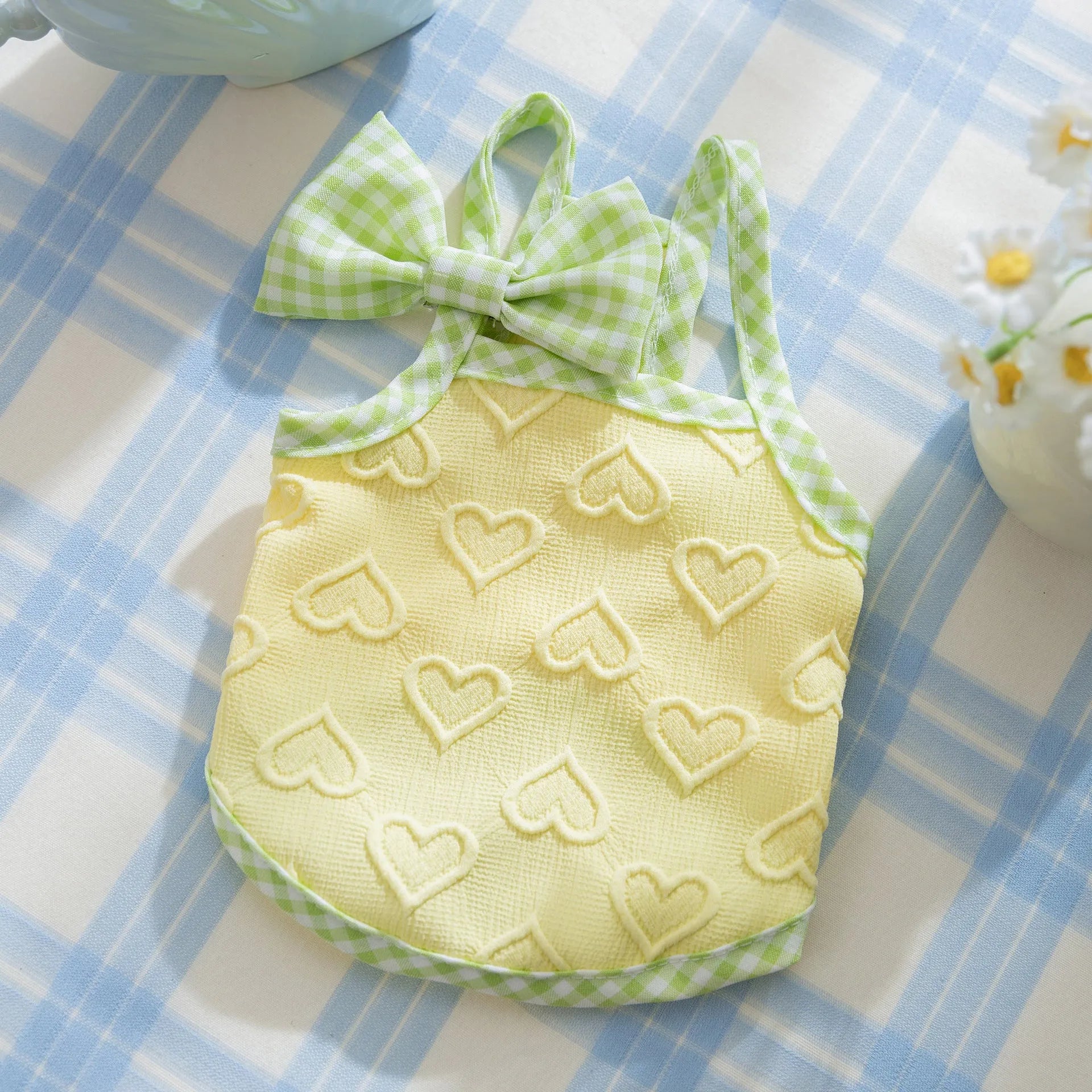 Small dog wearing heart relief texture bow suspenders vest in Bondi Blue colour with matching hairband