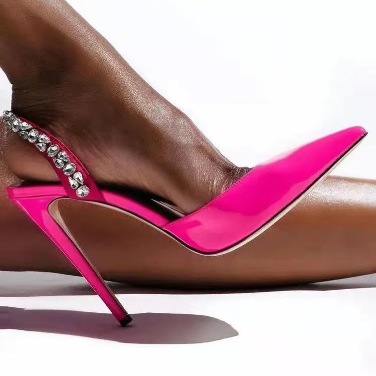 Rhinestone embellished pointed toe high heel sandals in glossy patent leather.