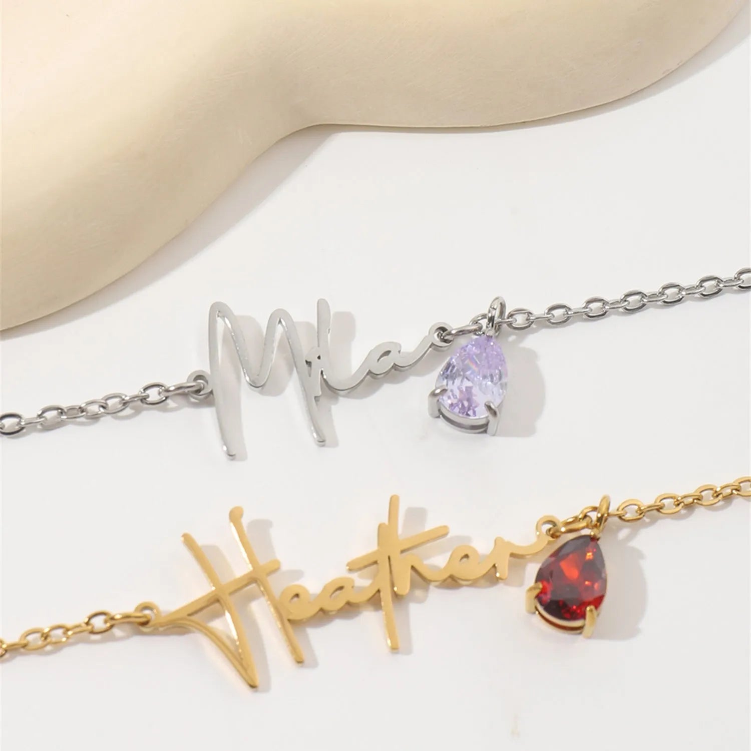 Stainless steel custom name necklace with DIY personalised pendant in silver finish on a plain background