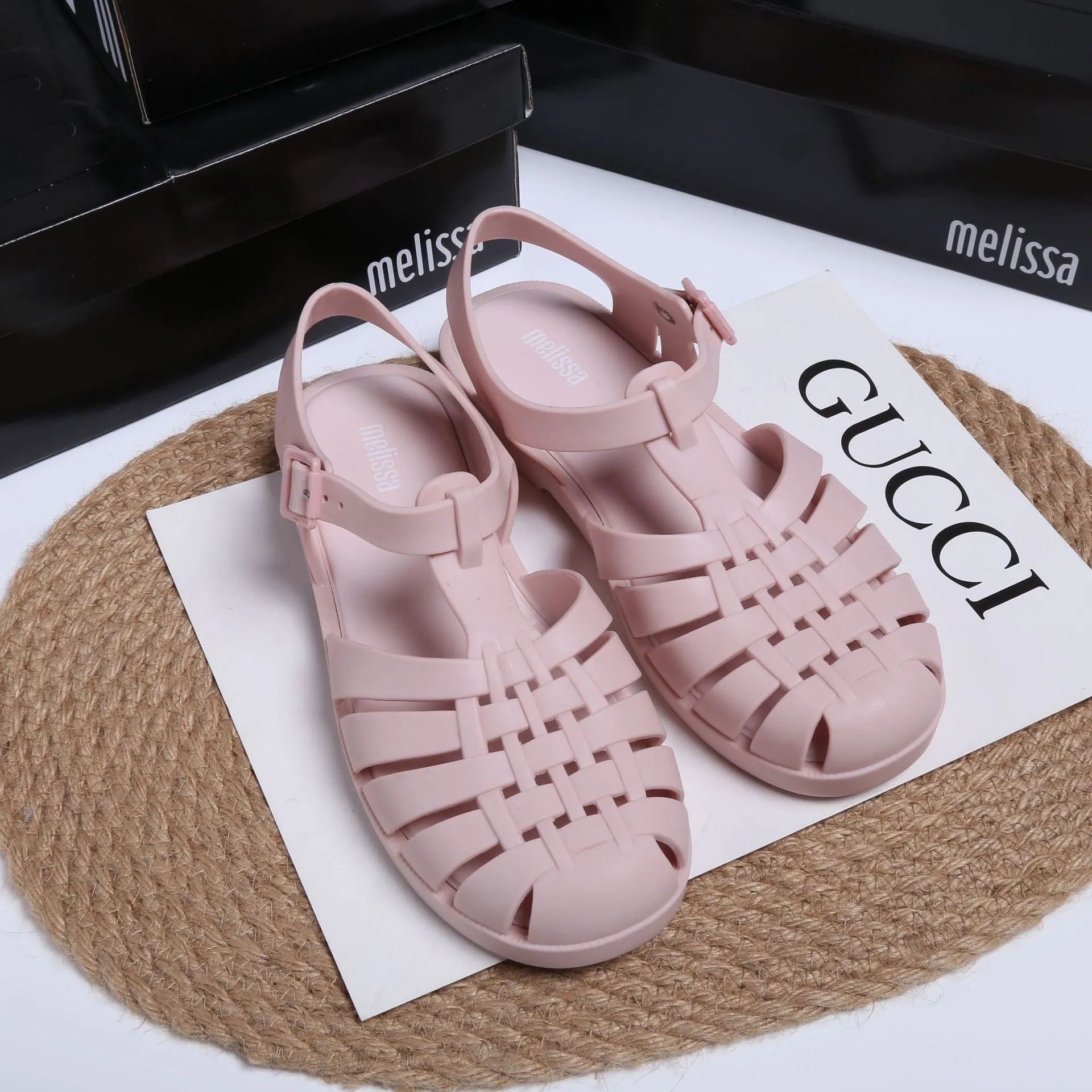 Black Roman-style sandals with buckle fastening and hollow-out design on low-top PVC upper