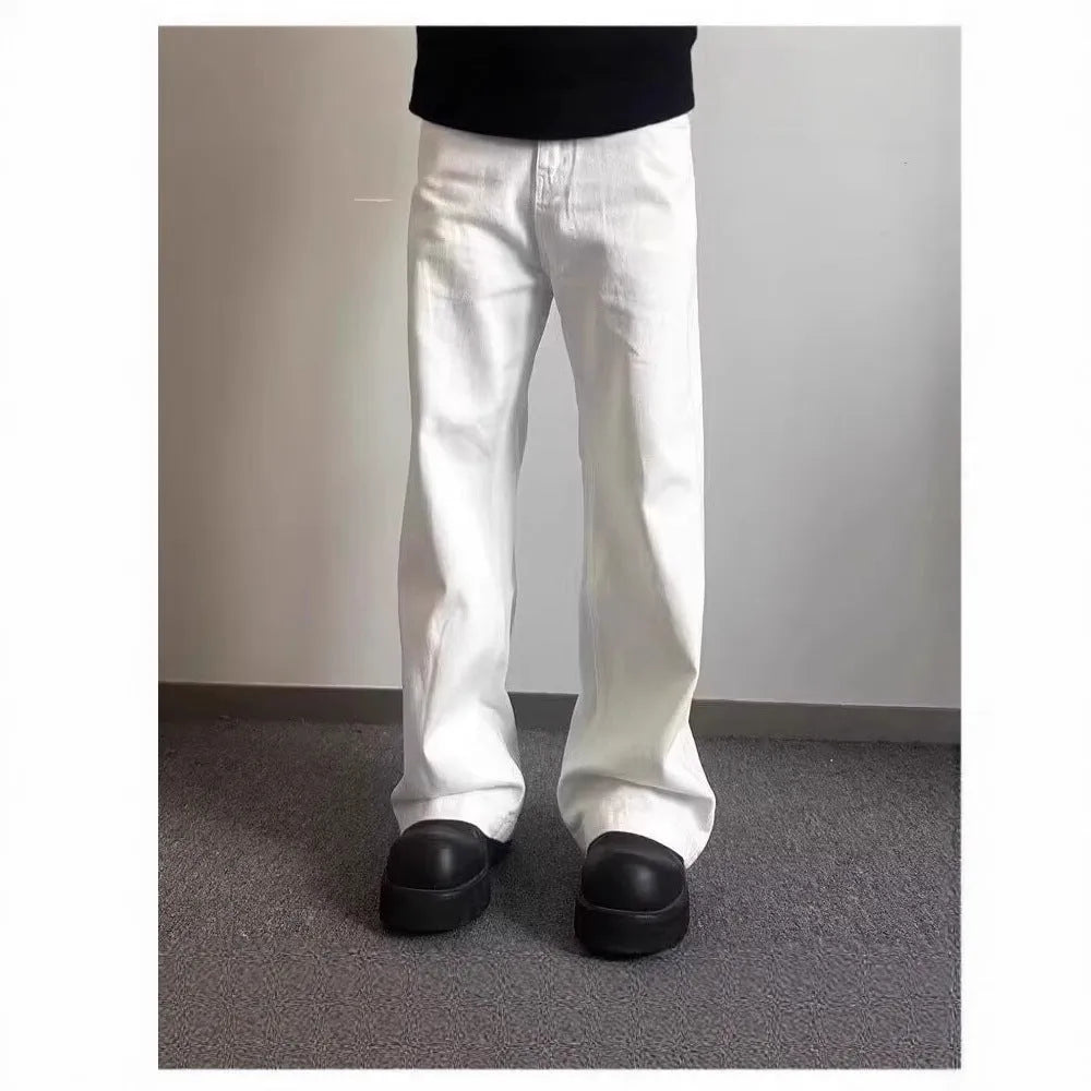 Men's white straight-leg wide-leg cotton denim jeans on a plain background.
