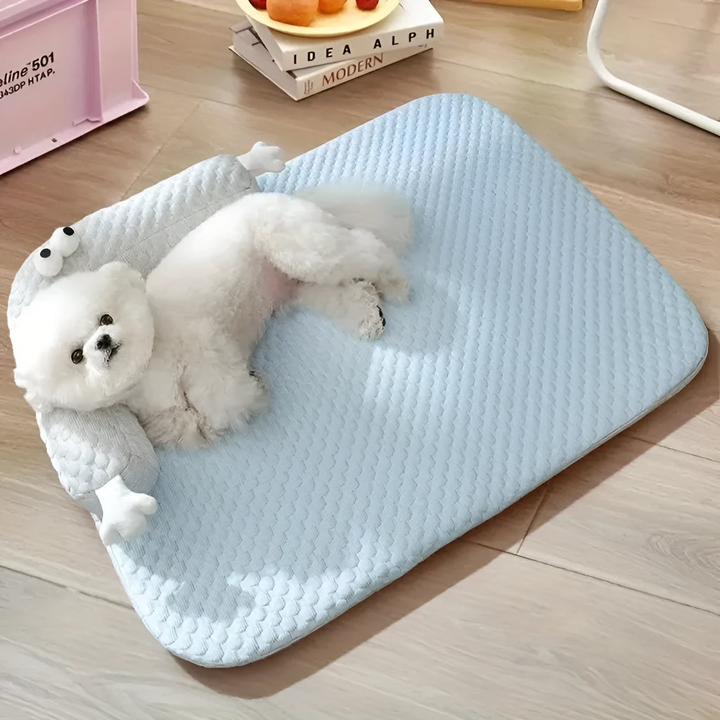 Blue pet cushion with large monster face design for dogs and cats on a wooden floor.