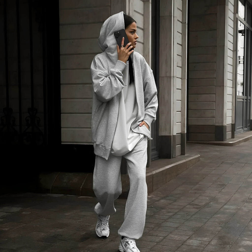 Women's red street style two-piece set with long-sleeved coat and matching trousers, loose fit.