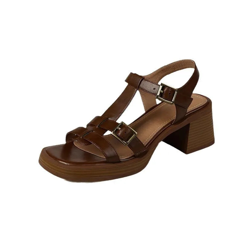 Black retro women's platform sandals with a T-buckle fastening and chunky heel.