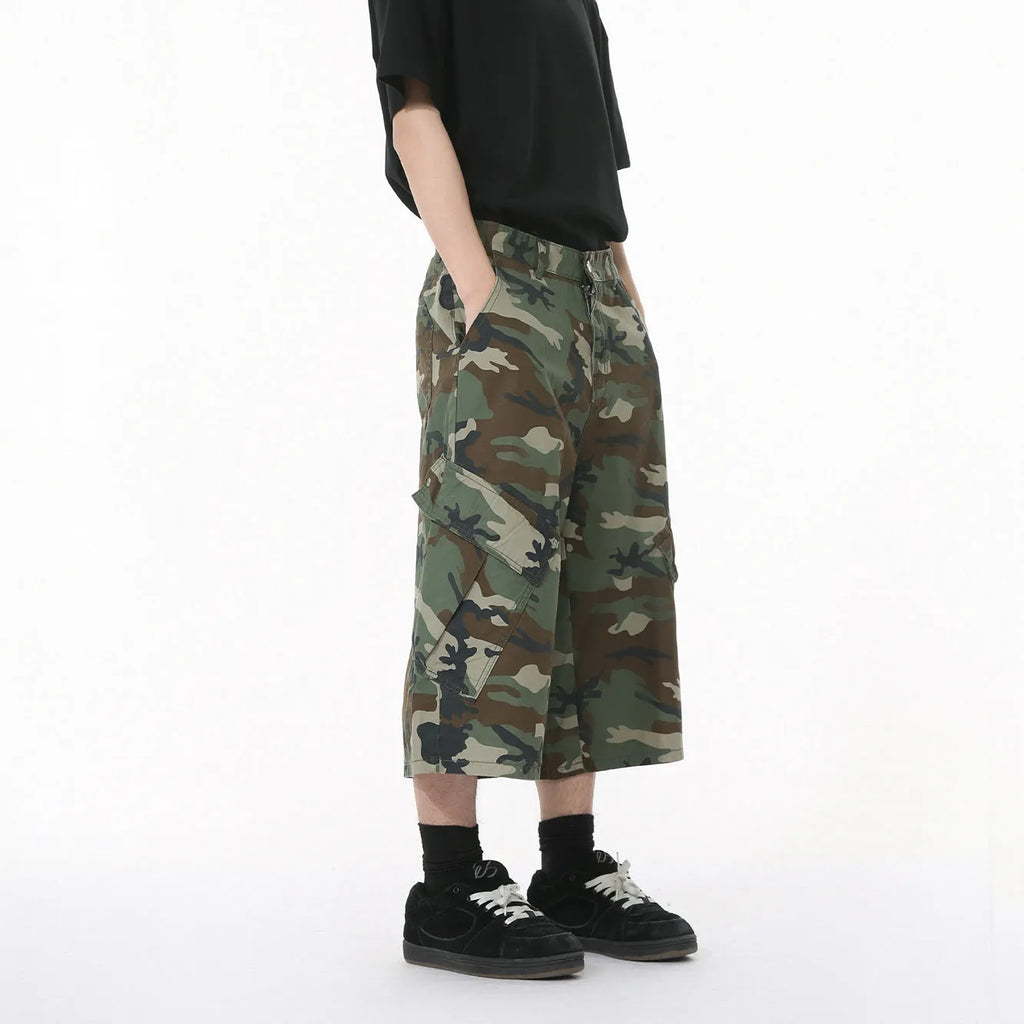 Men's camouflage coloured wide-leg cotton cargo trousers with large patch pockets and side stitching.