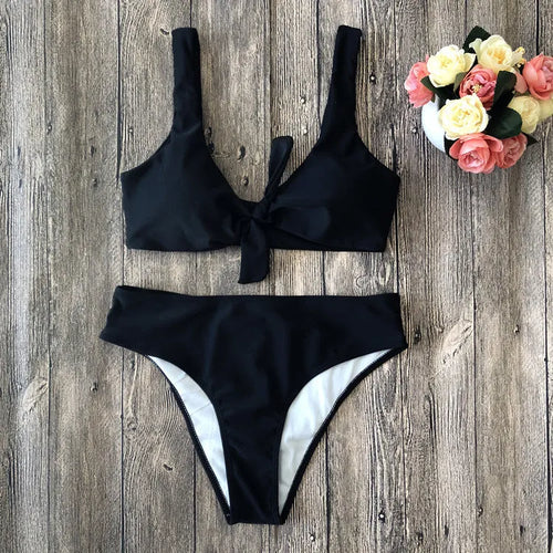 Women's solid colour bikini set showing bra top and matching panties in polyester fabric