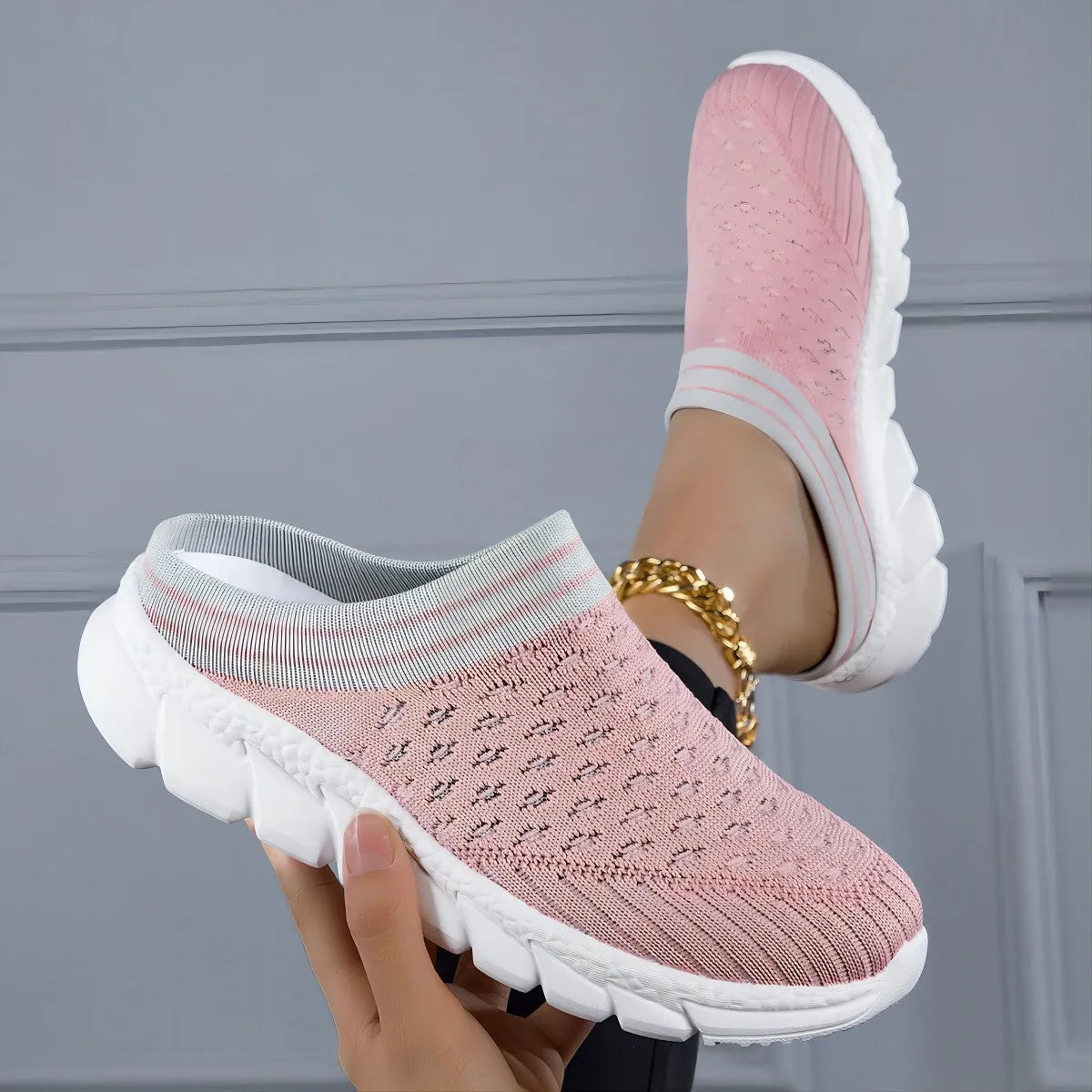 Women's black flyknit semi-slipper sock shoes with striped pattern and hollowed-out sewing lines on a lightweight sole.