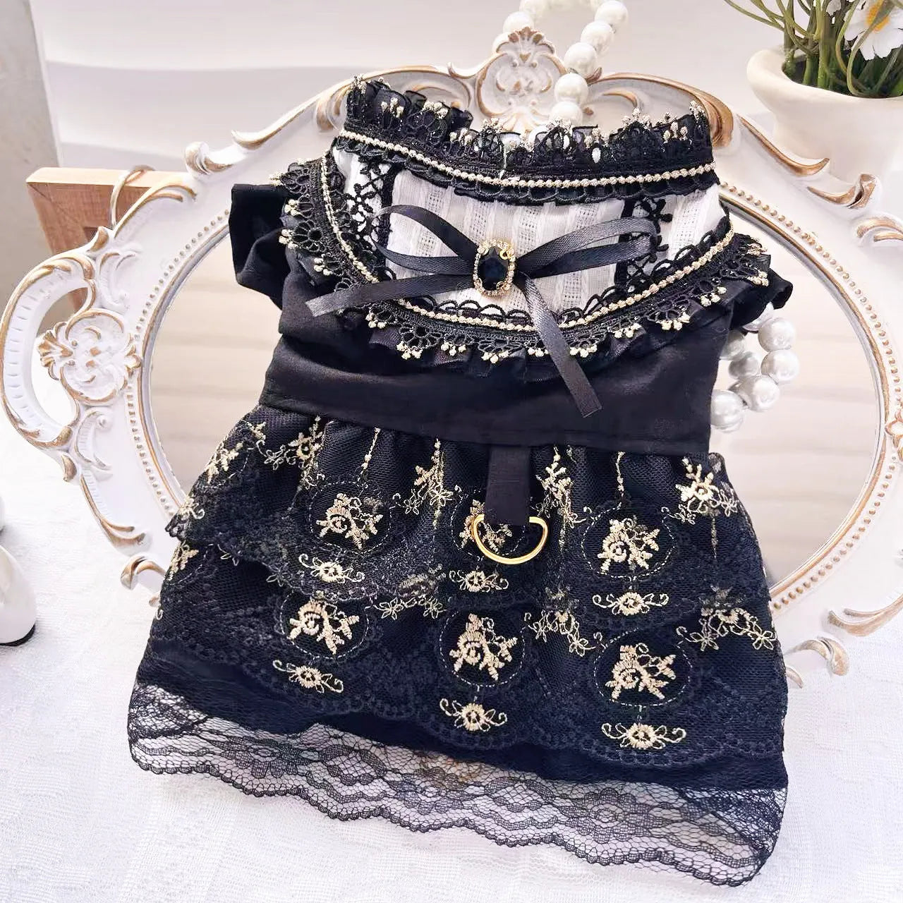 Golden polyester gothic princess style dress for a small dog on a mannequin.