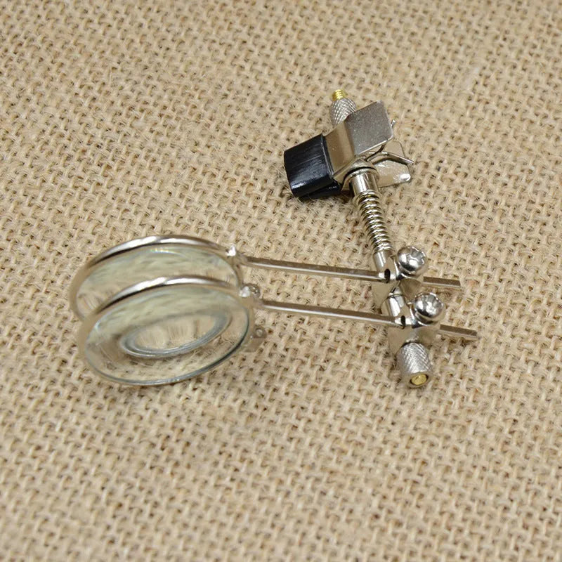 Auxiliary reading glasses magnifier with metal double clip and glass lens.