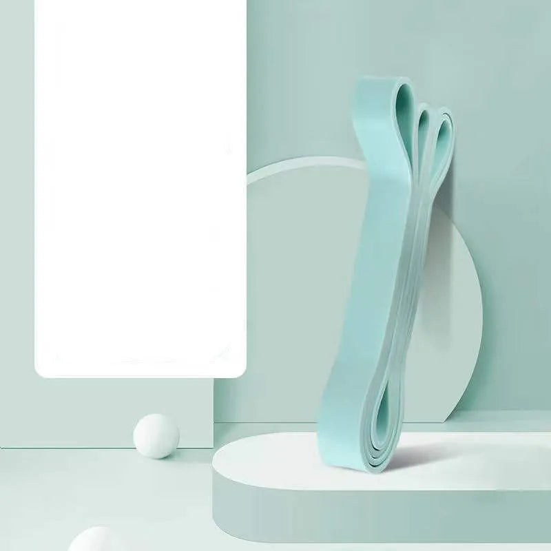 Set of five TPR stretch resistance bands in light blue, grey, pink, fruit green, and dark blue on a white background