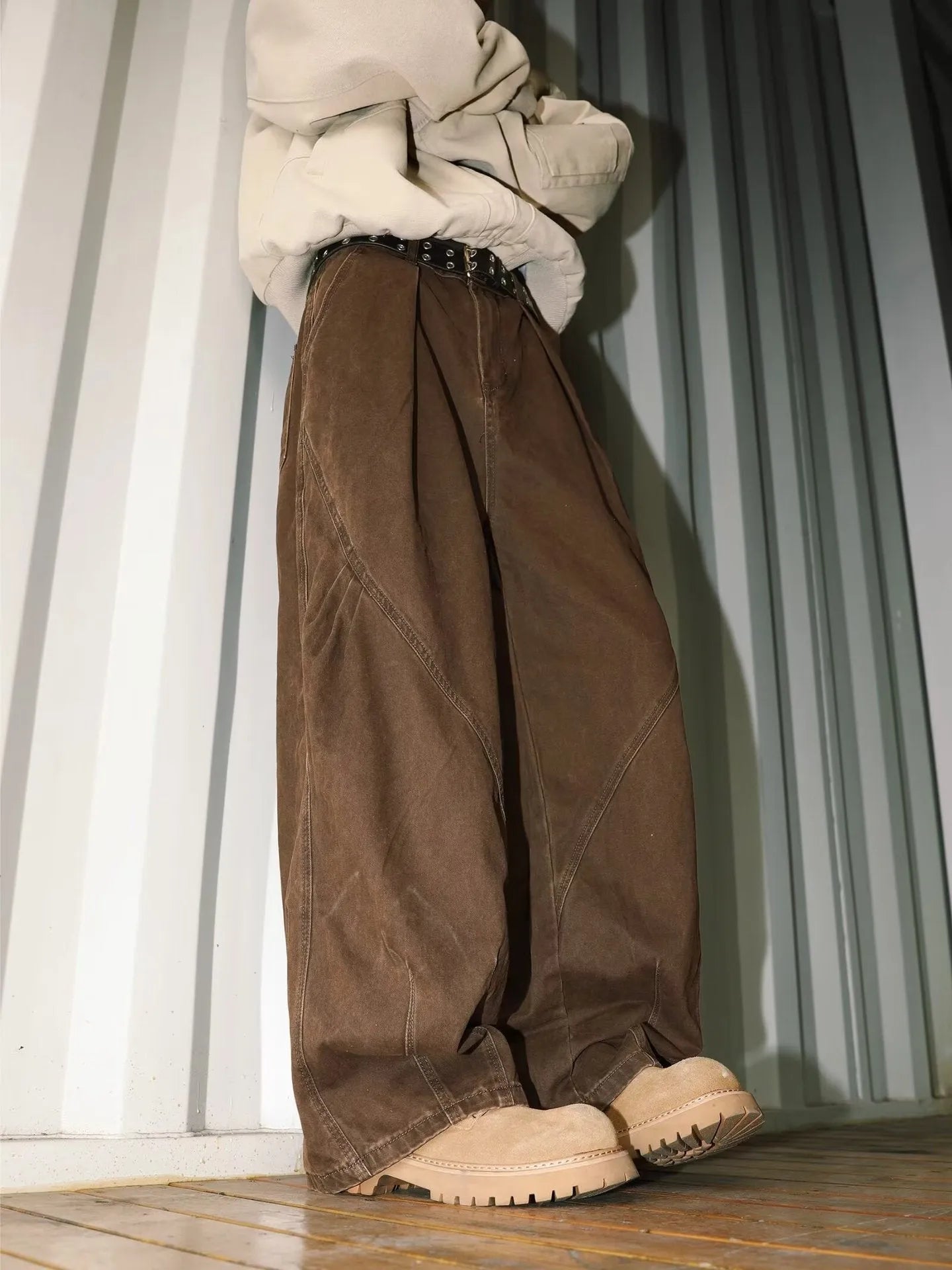 Men's pleated straight loose trousers in black striped pattern showing straight leg design