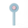 Blue pet grooming brush with self-cleaning button and angled metal pins for cats and dogs