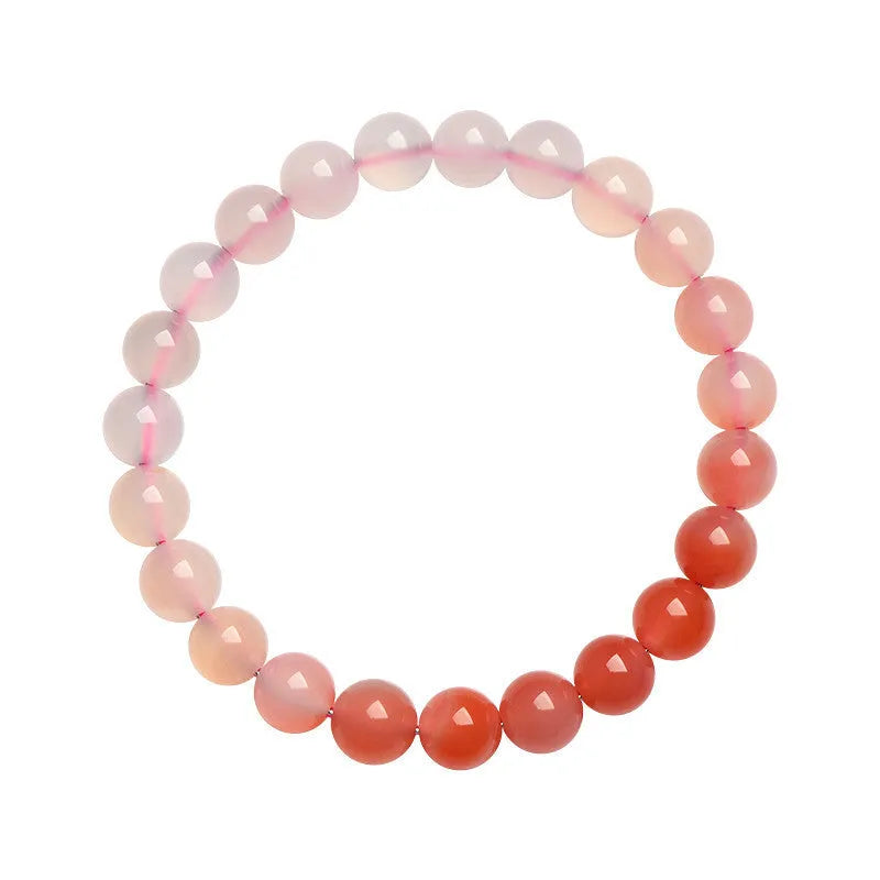 Natural gradient Yanyuan agate beaded bracelet with geometric polished beads on a wrist.