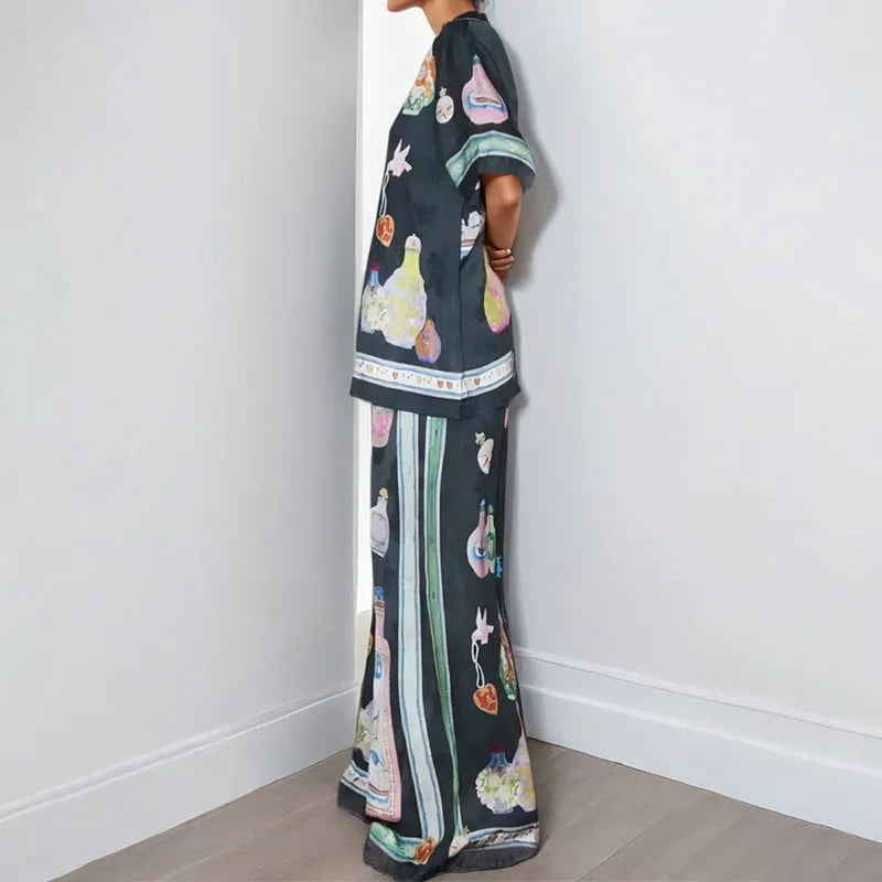Black women's casual set with cartoon print, showing cardigan and matching trousers