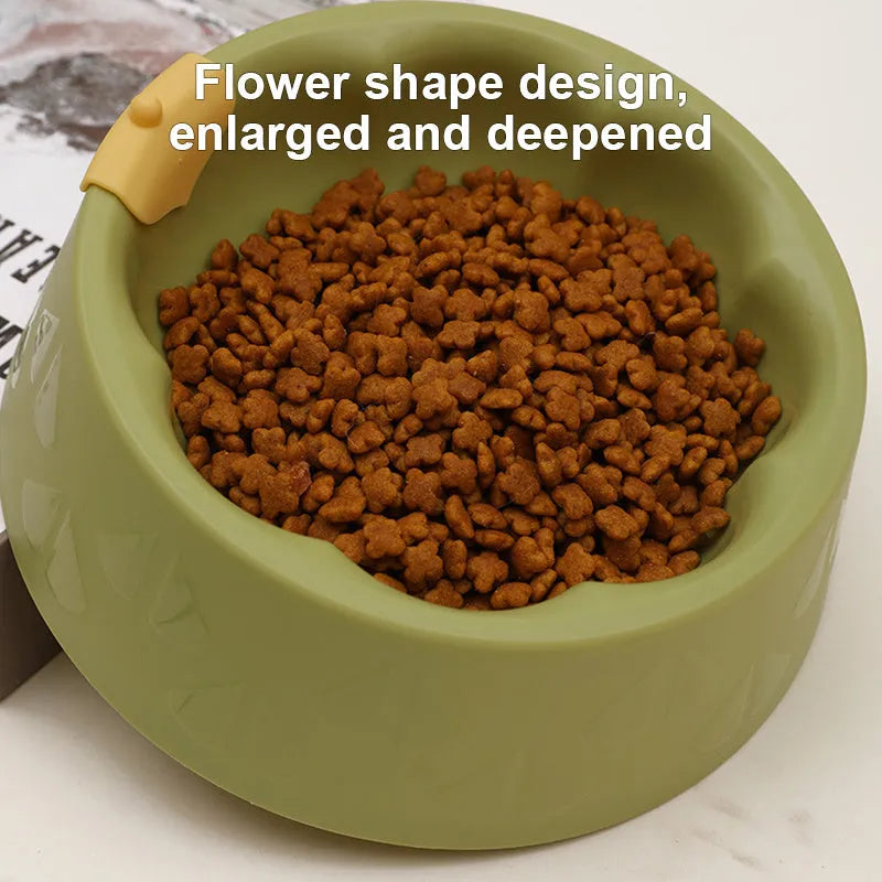 Green plastic double pet bowl for dog and cat food and water on a white surface