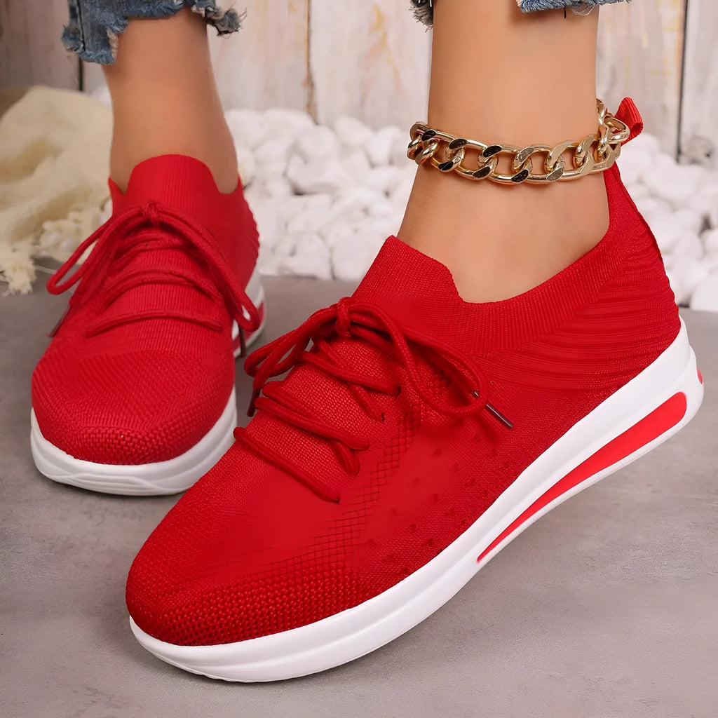 Women's red fly-knit casual sneakers with round toe and lace-up front.
