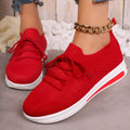 Women's red fly-knit casual sneakers with round toe and lace-up front.