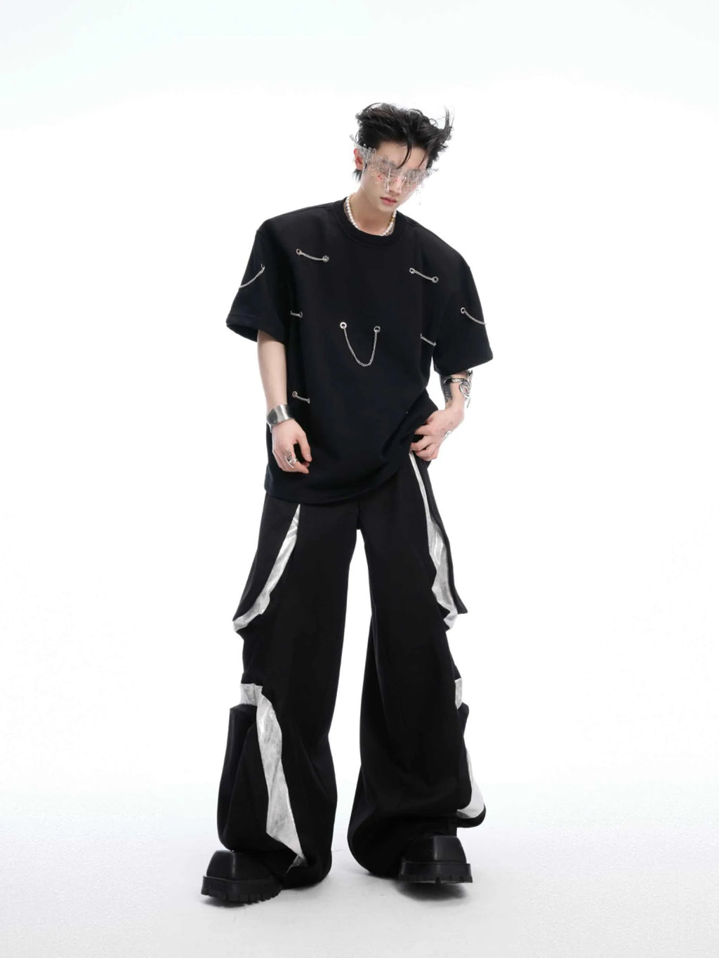 Black cotton blend T-shirt with metal chain detail on padded shoulders, short sleeves, round neck, front view