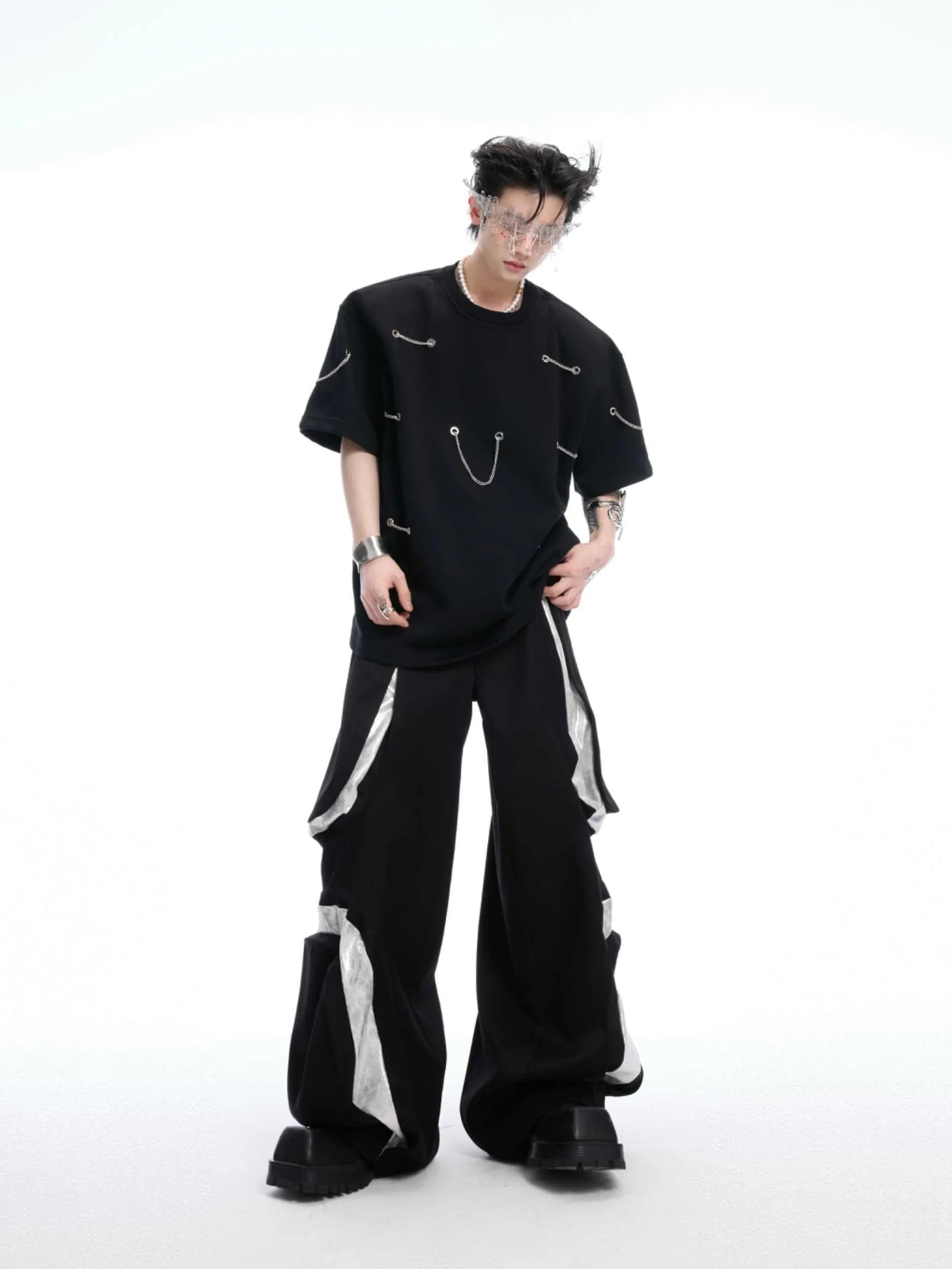 Black cotton blend T-shirt with metal chain detail on padded shoulders, short sleeves, round neck, front view