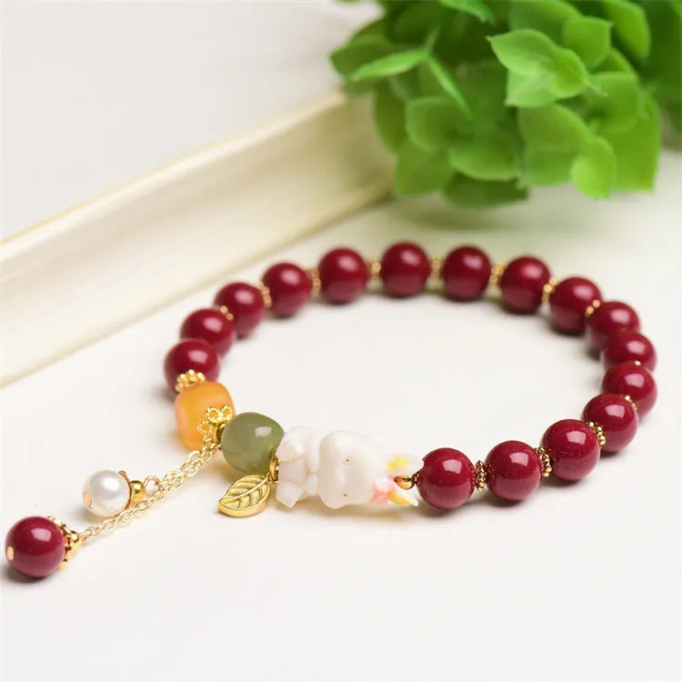 Natural red cinnabar bracelet for women featuring a carved rabbit design, shown in 8mm and 10mm width options.
