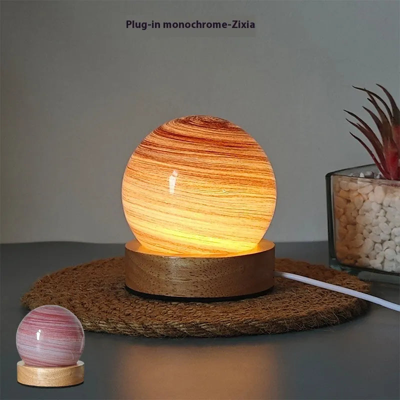 Planet night light with USB cable and base in modern simple design showing spherical shape