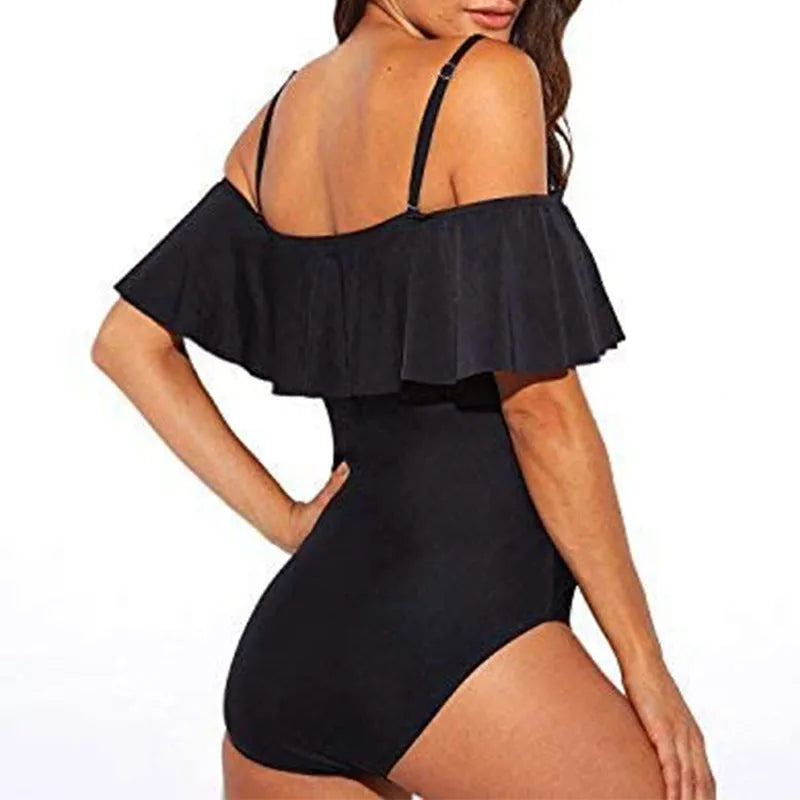 Black one-piece swimsuit with cut-out side detailing and ruffled straps