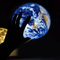 Earth and Moon LED projector lamp with adjustable rotating bracket on wooden surface