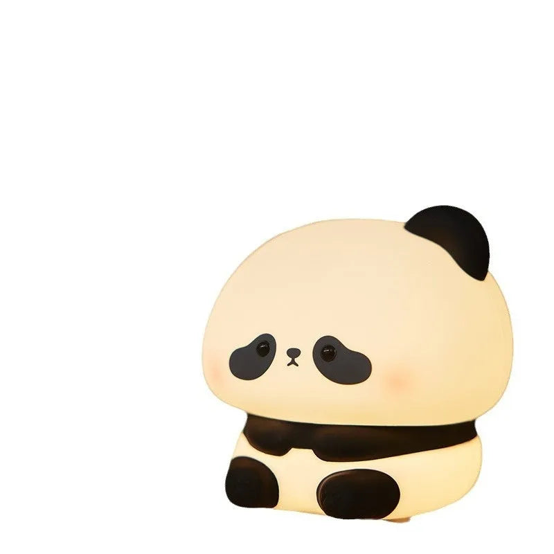 Panda LED night light with soft silicone head, USB rechargeable, touch control, colourful lights, on a bedside table