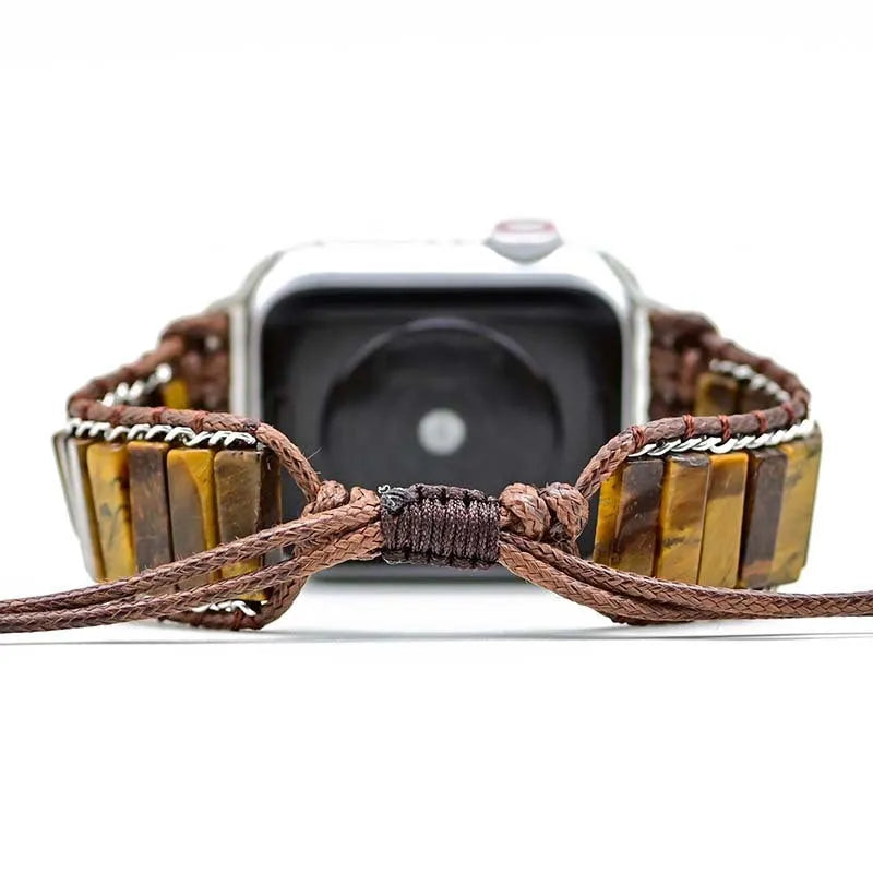 Men's adjustable textile watch strap with rectangular tiger eye stone, showing bohemian design and clasp detail.
