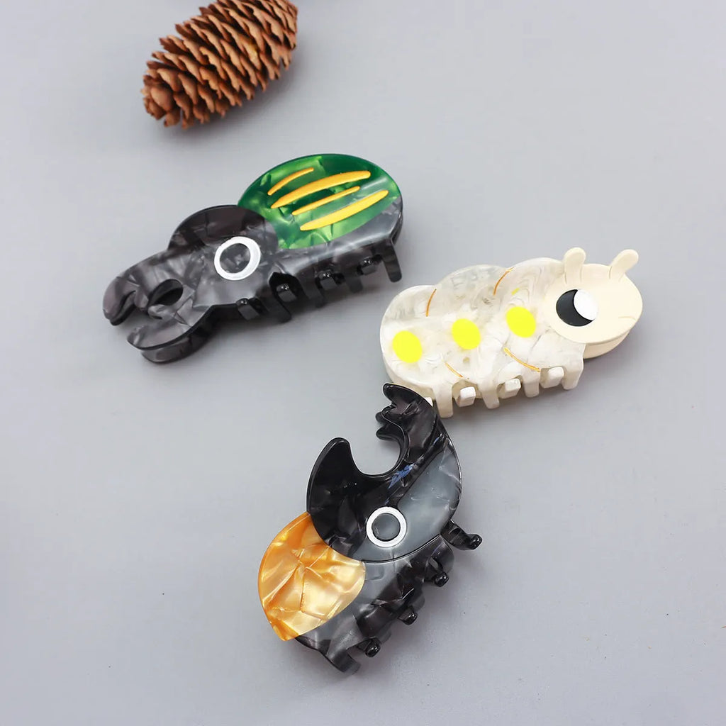 Handmade cellulose acetate insect beetle grip desk accessory with cartoon caterpillar design