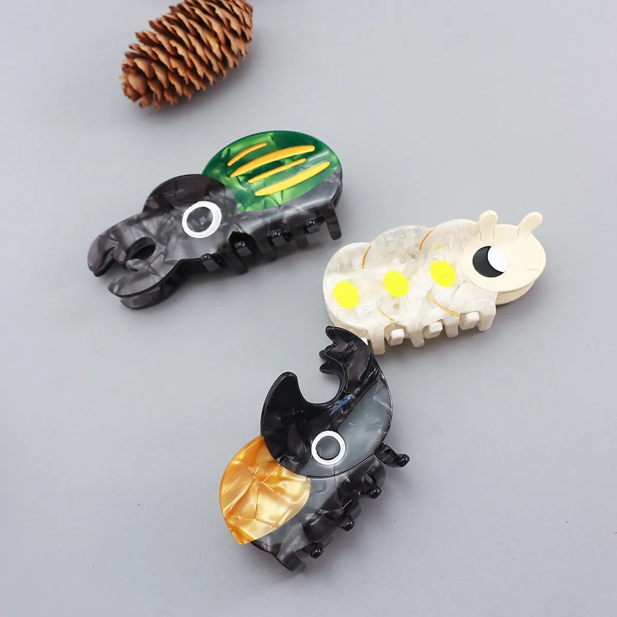 Handmade cellulose acetate insect beetle grip desk accessory with cartoon caterpillar design