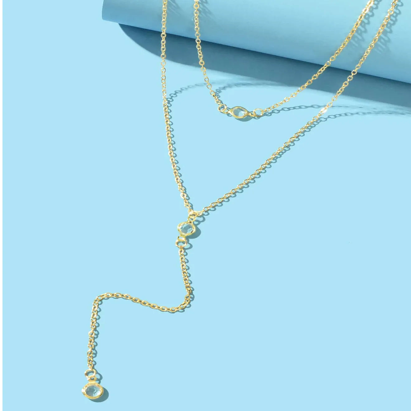 Alloy O-ring chain necklace with geometric pendant in gold finish on female neckline