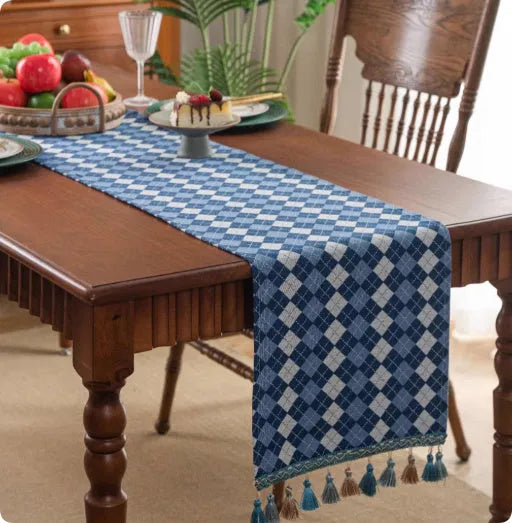 Country European retro style table flag with long handwoven tassels draped over a wooden sideboard.
