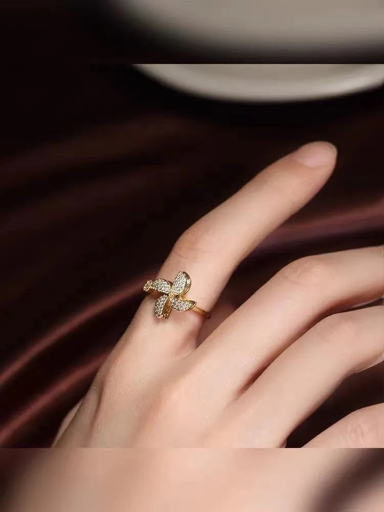 Geometric windmill rotating ring in gold electroplated finish showing circular design with movement elements