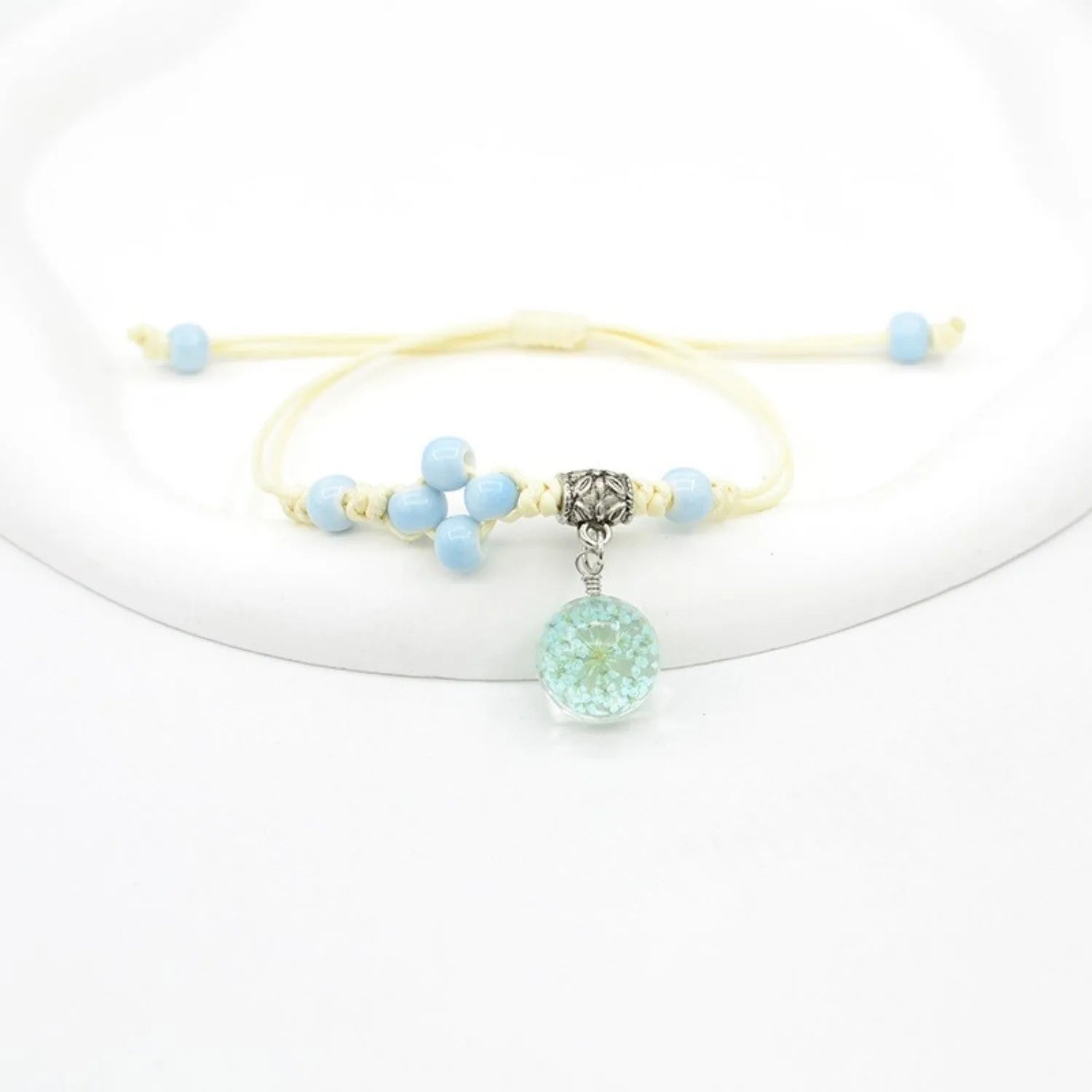 Hand-woven glass bracelet with 1.4cm beads containing real dried flowers in various colours